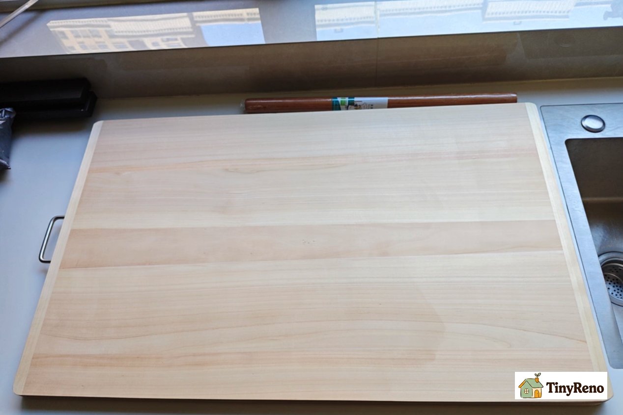 A solid wood cutting board is both practical and can cover up an unattractive countertop